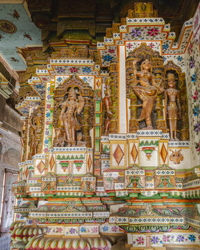 View of intricate carvings and vibrant colors adorn the walls of a temple, showcasing elaborate designs and cultural heritage, Bikaner, Rajasthan, India.