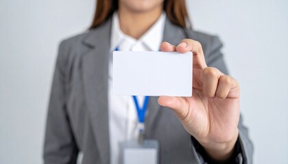 A professional holding a blank business card. The card is clean and ready for personalization