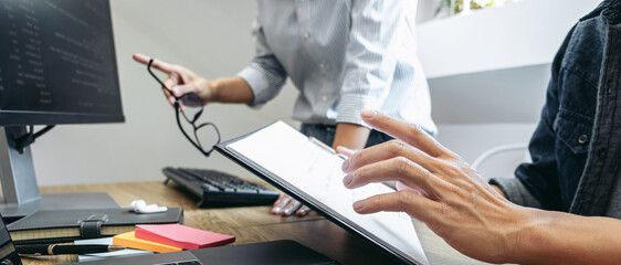 Writing codes and typing data code technology, Programmer team working on web site project in a...