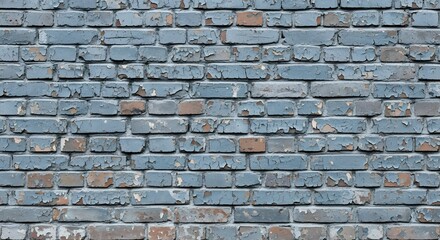 Fototapeta premium A close up of a brick wall with peeling paint showing signs of age and weathering over time