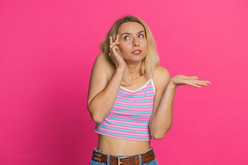 I don't know what to say. Confused Caucasian young woman feeling embarrassed about ambiguous...