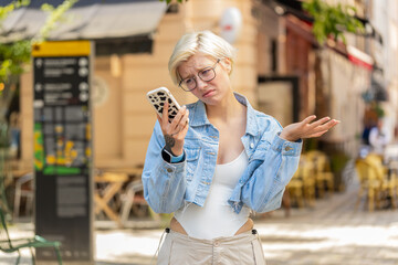 Caucasian young woman use smartphone typing browsing, loses becoming surprised sudden lottery...