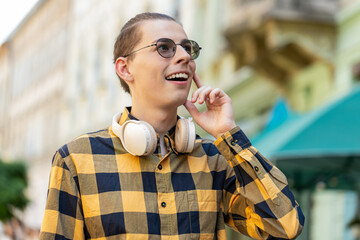 Caucasian man tourist walking in urban city street background in summer daytime outdoors. Happy...