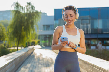 Portrait of young fitness sport runner woman training, wearing headphones listening to music from...