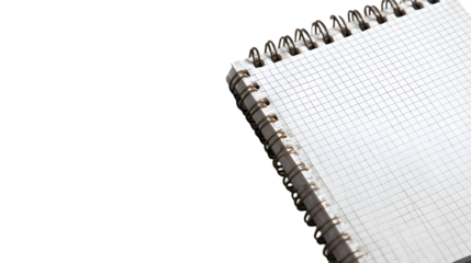 A close up of a spiral notebook with graph paper on a TRANSPARENT background in a diagonal position