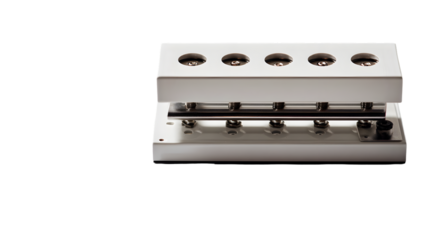 Close up of a white metal machine with five circular openings and a TRANSPARENT knob on the right side