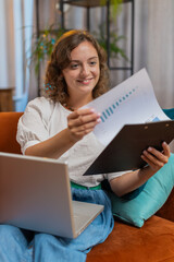 Woman accountant working with financial graph documents, calculate taxes for charts and graph...
