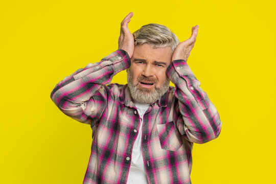Caucasian middle-aged man on yellow background showing powerless frustration, hopeless stress, depression. Angry mature guy tension desperate emotional turmoil despair rage nervous negative expression