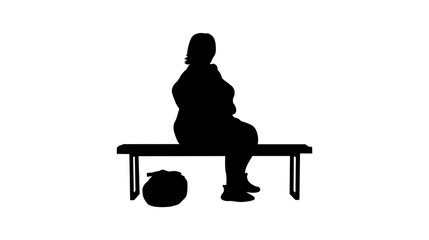 Fototapeta premium A silhouette of a plus-size woman seated on a park bench.