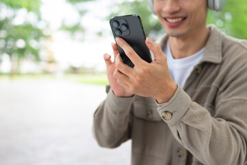 Young man's hand using a mobile phone