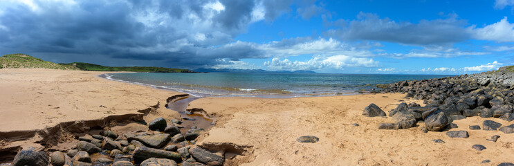 Redpoint Beach, warm red sand meet the clear blue sea near Gairloch, in the Scottish Highlands