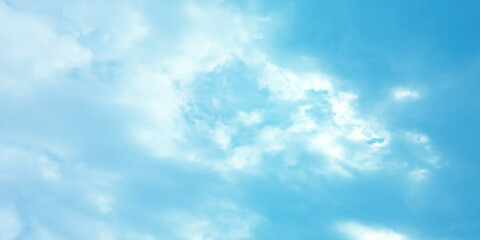 Fototapeta premium Blue sky, sun, clouds. A peaceful moment with underlying complexity. A reflection of the sky on thin clouds. Hidden emotions beneath a bright exterior like feeling melancholic on a good day background