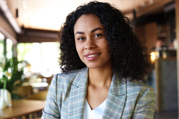 Portrait of smiling Latin American woman in cafe