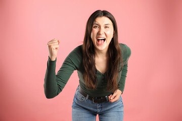 Portrait of emotional woman on pink background