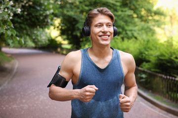 Sporty man with headphones running in park