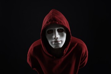 Anonymity. Man wearing mask on dark background