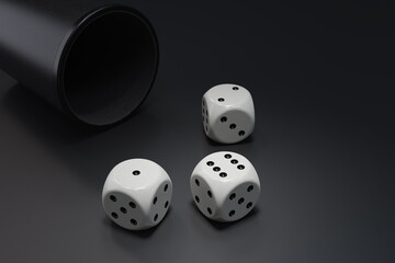 Three dice with dcup on dark background. 