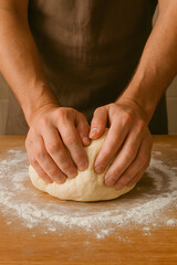 Kneading Dough: Hands gently working a soft dough ball on a wooden surface, the flour creating a visual texture of home baking. A close-up captures the intimacy of making bread, ready for baking