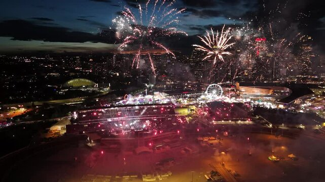 A stunning night view of Calgary, Alberta, featuring vibrant fireworks from the Calgary Stampede celebration illuminating the downtown skyline. The video captures iconic buildings like the Bow, Calgar
