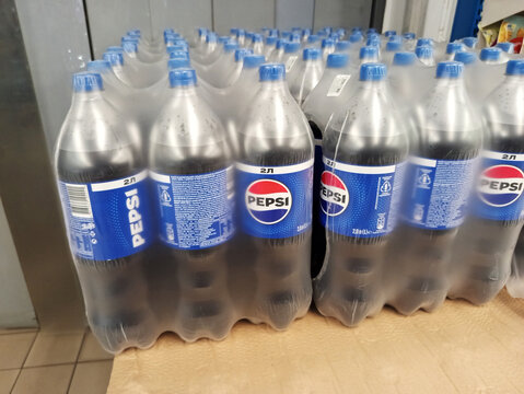 Zvyagel, Ukraine - July 10, 2025: Bottles of Pepsi soft drink arranged neatly on display, showcasing vibrant branding and packaging in a retail environment with copy space