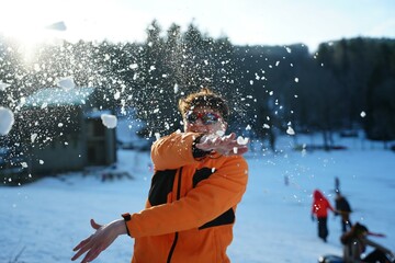 Teen Enjoys Snowball Fight in Winter Wonderland