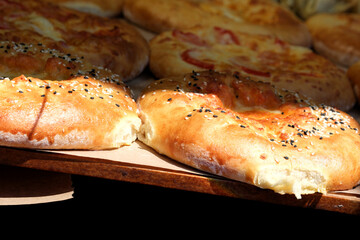 Freshly baked bread rolls showcasing golden crust and savory toppings