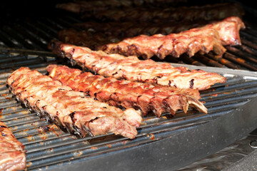Sizzling ribs being grilled to perfection at a summer barbecue event
