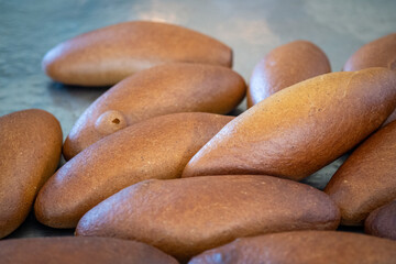 Freshly Baked Traditional Bread Loaves on a Metal Surface