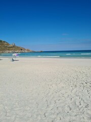 Praia Grande (Big Beach) Arraial do Cabo, Rio de Janeiro - Brazil: sunny morning, coastal atmosphere of the winter, white sand and crystal-clear blue waters in Brazilian Caribbean.