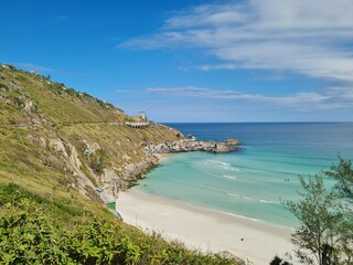 Praia Grande (Big Beach) Arraial do Cabo, Rio de Janeiro - Brazil: sunny morning, coastal atmosphere of the winter, white sand and crystal-clear blue waters in Brazilian Caribbean.