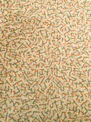 Texture of a beige background with gray and orange patterns resembling letters