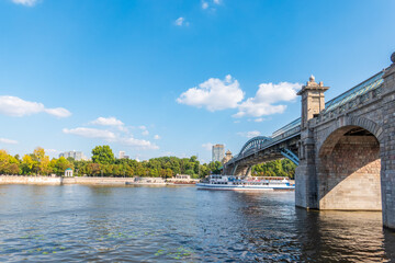 View of the Moscow river embankment, Pushkinsky bridge and cruise ships at sunset.