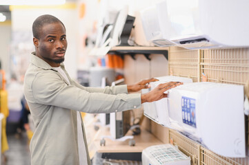 Customer choosing air conditioner in electronics store
