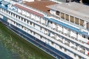 Cruise ship docked by the riverside overlooking calm water in the afternoon