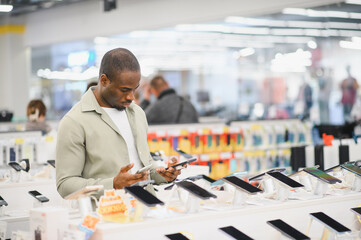 Customer comparing smartphones in electronics store