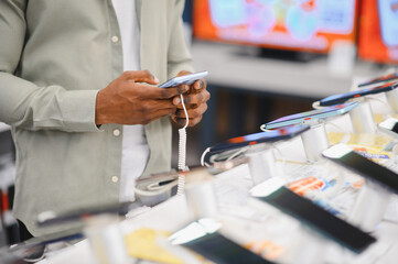 Customer trying new smartphone in electronics store