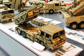 Military cars, trucks, models on a white background, at a military exhibition in Baku, Azerbaijan.
