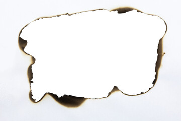 Large burnt hole in white paper creating a grunge frame with scorched edges from fire. Abstract vintage template for text or photos. isolated on white background with clipping path.