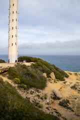 Stunning Torredembarra Lighthouse on rugged Mediterranean cliffs at Punta de la Galera, Tarragona, Catalonia. Perfect seaside nature and maritime beauty.