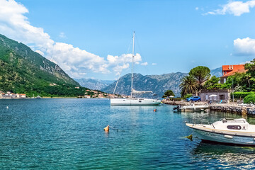 Sailboats docked along the serene waters of Boka Kotorska Bay in Kotor, Montenegro. Picturesque...