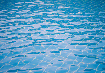 Obraz premium Blue Pool Water Texture, Ripples, Sunlight Reflections, Swimming Pool Surface, Azure Water, Summer Vibes.
