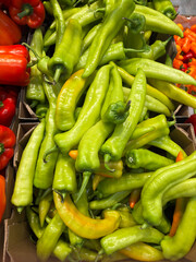 Crates filled with fresh yellow peppers displayed at the market. A vibrant and colorful composition.
