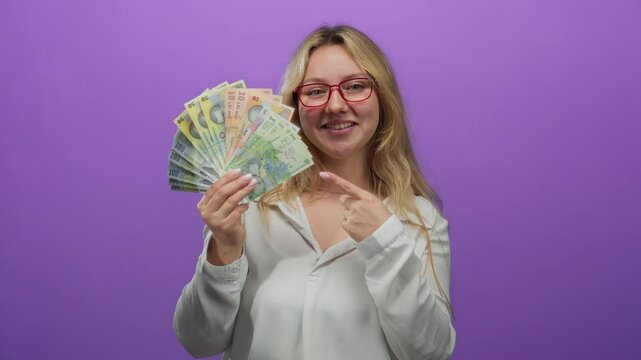 Young woman holding romanian banknotes over a vibrant purple background, smiling confidently to convey wealth and financial success.
