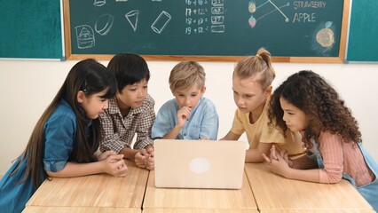 Top view diverse student looking at laptop and learning about coding engineering code and...