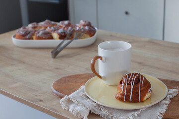 Coffee and Cinnabon with Baking Dish Behind