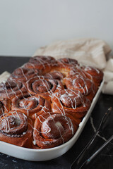 Freshly baked homemade cinnamon rolls on wooden table,  selective focus