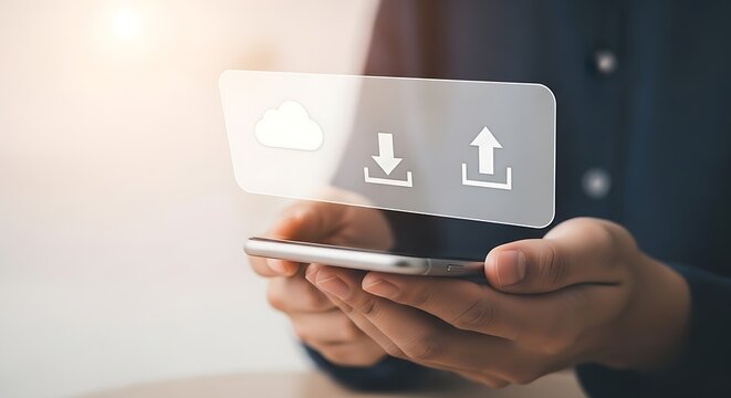 Person holding phone with cloud upload and download icons displayed on a transparent screen overlay - Powered by Adobe