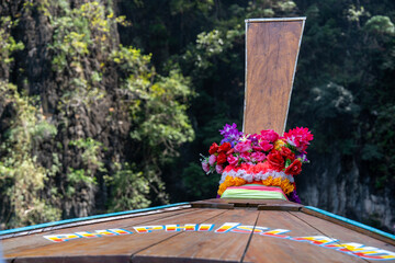 Bow of traditional Thai long-tail boat decorated with flowers in Pileh lagoon of Ko Phi Phi Leh...
