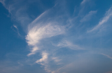 Wispy clouds drift gently across a brilliant blue sky, creating a serene and peaceful atmosphere...