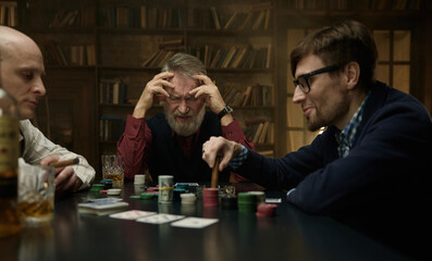 An intense poker game in a vintage library featuring men company
